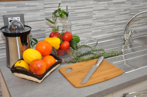 a bunch of fruits and vegetables on a kitchen counter at Maison Gentile in Lucca