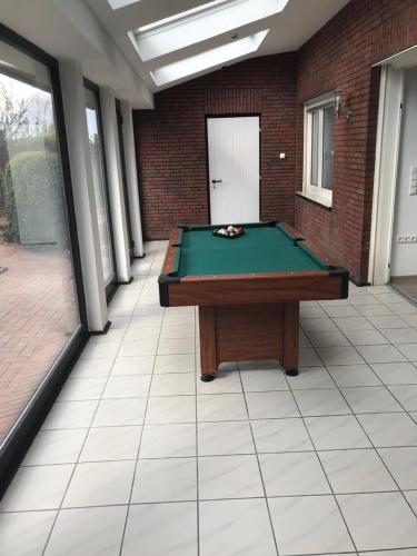 a room with a pool table in a building at Apartments Benser-Hof in Bensersiel