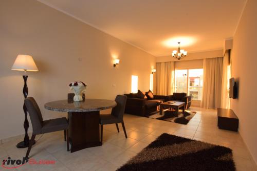 a living room with a table and a couch at Rivoli Suites in Hurghada