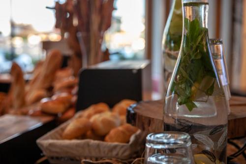 a table with a bottle of water and a basket of bread at Ibis Konya in Konya