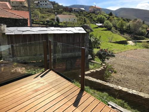 a deck with a view of a house at Refúgio dos Macedos in Bilhó