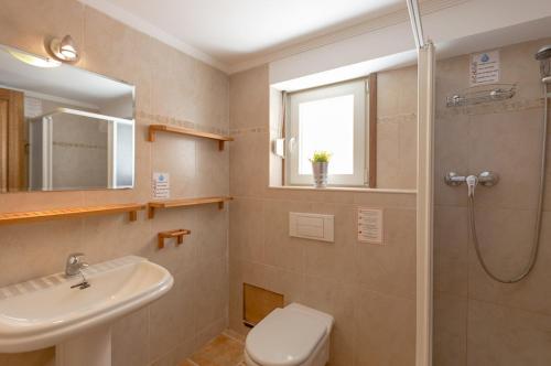 a bathroom with a toilet and a sink and a shower at Villas Guzman - Bernia in Calpe