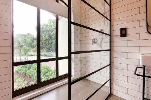 a bathroom with a shower and a window at The Rasmus in Pretoria