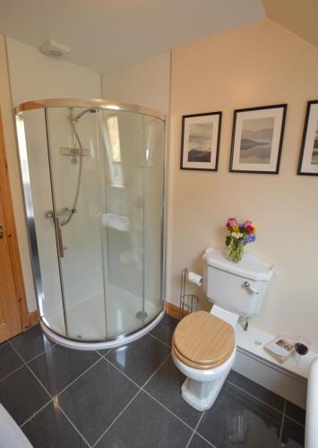 a bathroom with a shower and a toilet and a sink at Feochan Bheag in Oban
