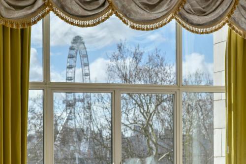 a window with a view of a tower in the background at The Savoy in London
