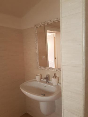 a bathroom with a sink and a mirror at Masseria Gianca in Cisternino