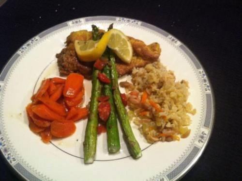 a plate of food with vegetables and rice on a table at A Mighty Oak B&B in Pilot Mountain