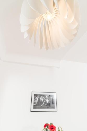 a white fan hanging from a ceiling with a picture at Zum Grazer Uhrturm in Graz