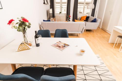 a living room with a white table and chairs at Zum Grazer Uhrturm in Graz