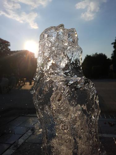 a sculpture of a person with the sun in the background at Kurhotel Anders in Bad Füssing
