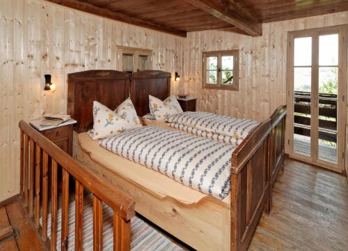a bedroom with a large wooden bed in a room at Ferienhof Stetter in Schöllnach