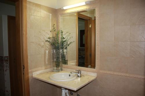 a bathroom with a sink and a mirror at Angela Guest House in Lagos