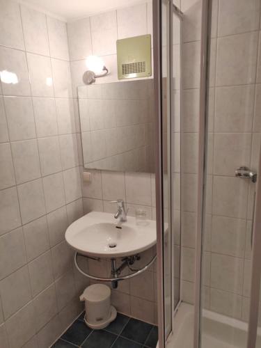 a bathroom with a sink and a shower at Pension Eder - Joker card included in summer in Saalbach Hinterglemm