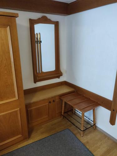 a dressing room with a table and a mirror at Pension Eder - Joker card included in summer in Saalbach Hinterglemm
