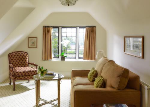 a living room with a couch and a chair at Danesfield House Hotel And Spa in Marlow