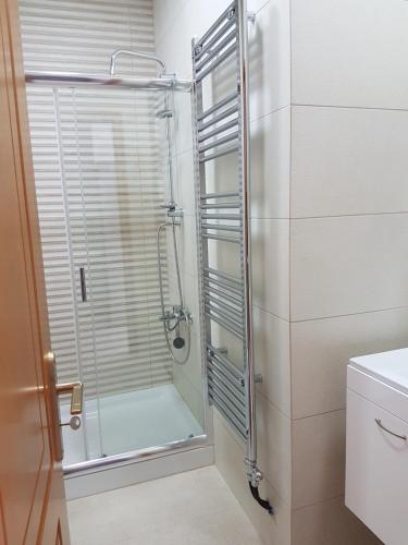 a shower with a glass door in a bathroom at The Heart of Kissamos Studios in Kissamos