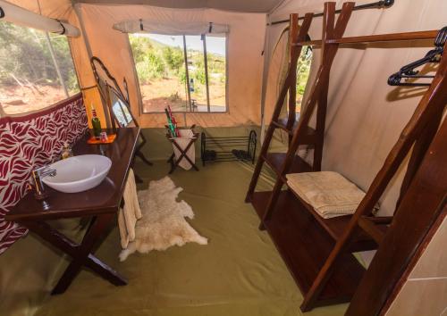 a room with two bunk beds and a sink and a mirror at Oldarpoi Wageni Camps in Keekorok