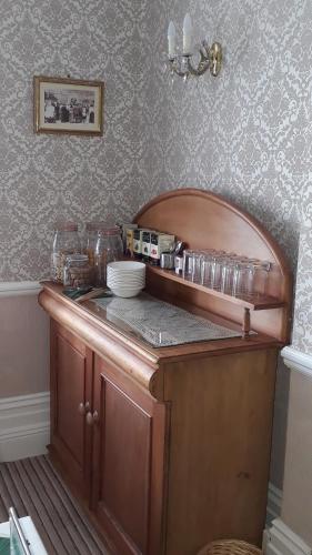 a kitchen with a wooden counter top in a room at Branstone Guest House in Llandudno