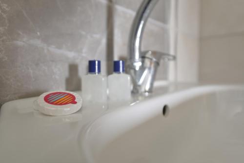a bathroom sink with a faucet and two bottles on it at Marbella Kale Beach in Akçakale