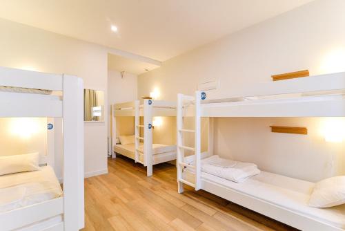 a room with three bunk beds in a hostel at SLO Hostel Lyon Saxe in Lyon