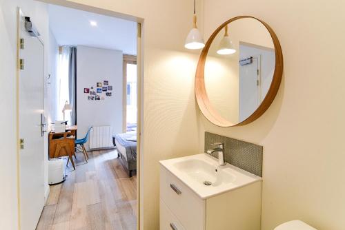 a bathroom with a sink and a mirror at Slo Lyon Saxe in Lyon