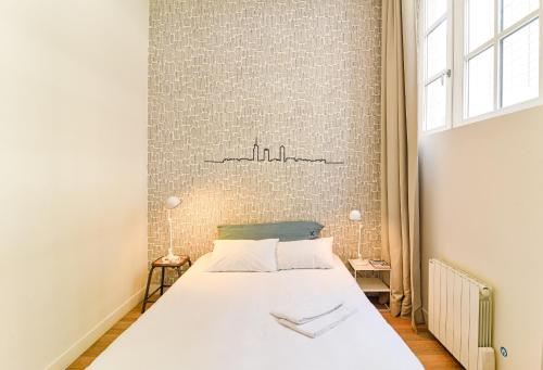 a bedroom with a large bed in a room at SLO Hostel Lyon Saxe in Lyon
