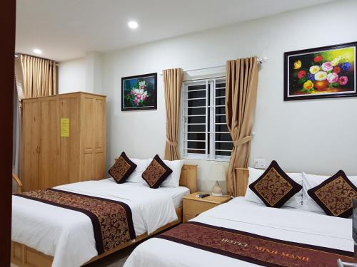 En eller flere senge i et værelse på Minh Manh Hotel