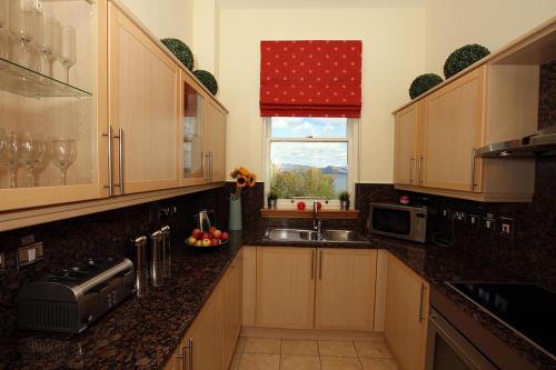 a kitchen with a sink and a window at No 15 Lomond Castle in Balloch