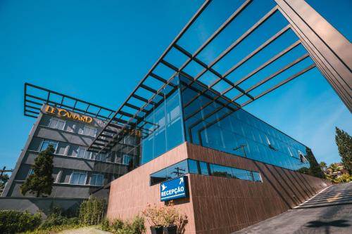a building with a sign on the side of it at Le CanarD Joinville in Joinville