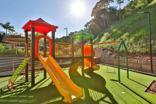 a playground with a slide in a park at Quality Hotel Blumenau in Blumenau