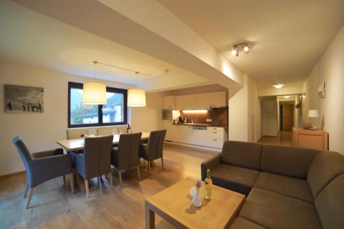 a living room and kitchen with a couch and a table at Appart Gastauer in Sankt Gallenkirch