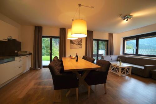 a living room with a table and a couch at Appart Gastauer in Sankt Gallenkirch