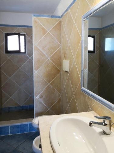 a bathroom with a sink and a toilet and a mirror at CHIA HOMES in Chia