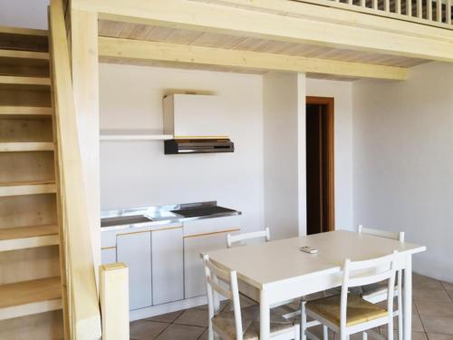 a kitchen and dining room with a table and chairs at CHIA HOMES in Chia