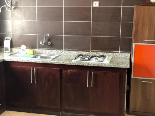 a kitchen counter with a sink and a stove at Oued Laou Sea View واد لاو in Oued Laou