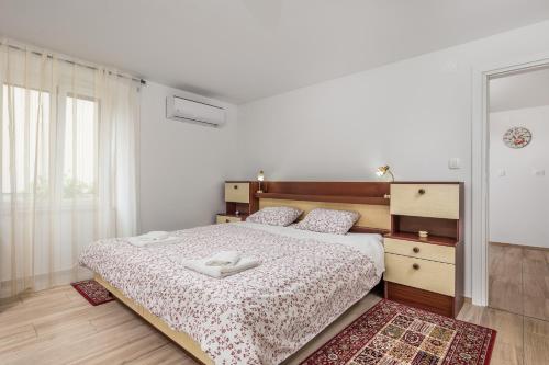 a bedroom with a bed with two white towels on it at Adeona apartments in Rijeka