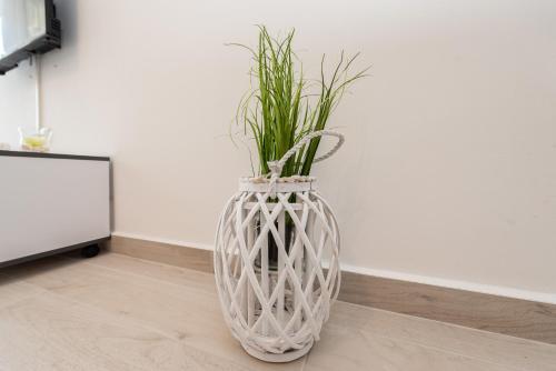 a large white vase with a plant in it at Ane in Zadar