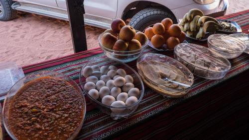 a table with bowls of eggs and other food on it at Arabian Nights in Wadi Rum