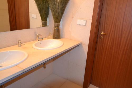 a bathroom with two sinks and a mirror at Casa De Alfena in Póvoa de Lanhoso