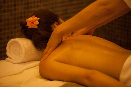 a woman laying on a bed with a flower in her hair at Sousse Palace Hotel & Spa in Sousse