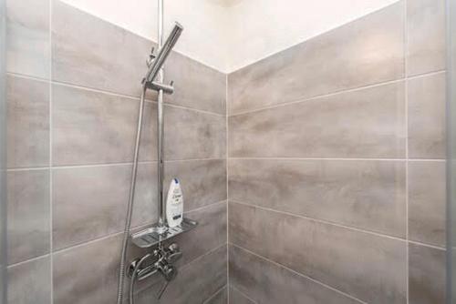 a shower in a bathroom with a shower head at Ane in Zadar