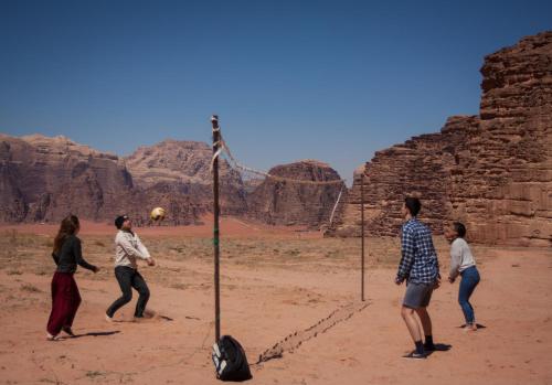 a group of people playing volleyball in the desert at Arabian Nights in Wadi Rum