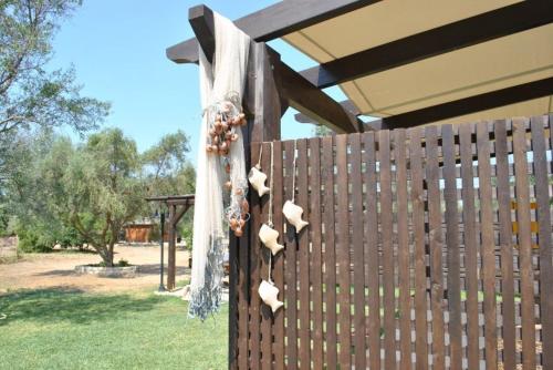 a fence with a bunch of seashells on it at 5 Stars Villas in Svoronata