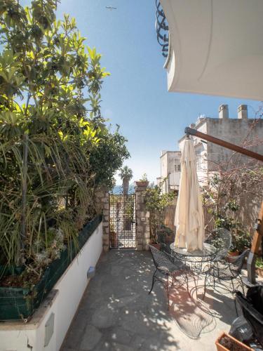 a patio with two chairs and an umbrella at Villa Silia in Capri