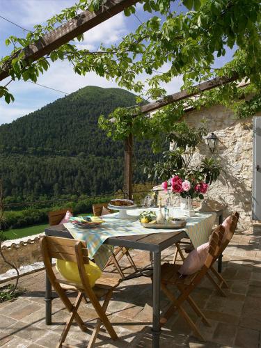 a table and chairs on a patio with a view at Borgo di Pianciano in Spoleto