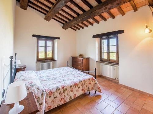 a bedroom with a bed and two windows at Apartment in Sant'Angelo near Medieval Town in SantʼAngelo in Vado