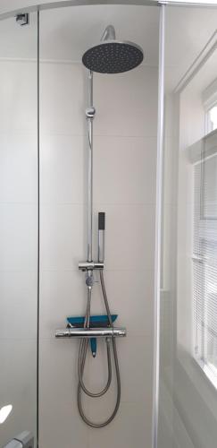 a shower in a bathroom with a glass shower stall at Vakantiehuis Katwijk in Katwijk