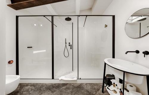a bathroom with a glass shower and a sink at A.D. 1768 Boutique Hotel in Ragusa