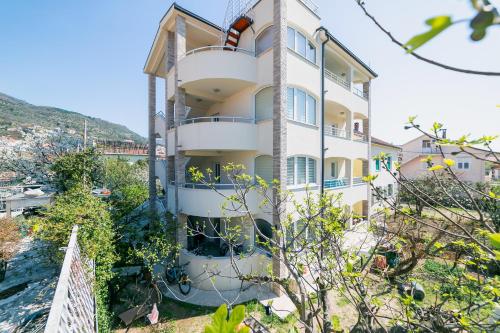 a building with balconies on the side of it at Apartmani Tripović in Tivat