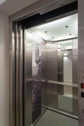 a elevator lobby with a window with a picture of a lighthouse at Alojamento da Vila in Valença
